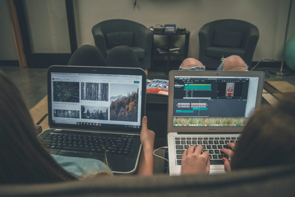 two people on couch with laptops